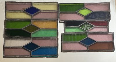 four stained glass squares with different colors of paint on them