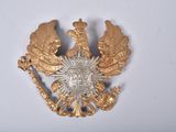 a gold brooch with a double headed eagle on it