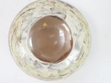 a white and brown bowl on a white surface