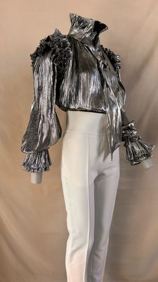 silver metallic blouse with ruffled sleeves and cuffs on mannequin mannequin mannequin mannequin mannequin mannequin mannequin mann