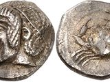 a silver coin with a woman ' s face on it