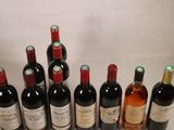 several bottles of wine are lined up in a row on a table