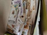 a cardboard box full of stamps and postcards