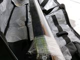 a bag with a baseball bat inside of it on the floor