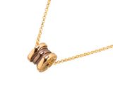 the necklace is made of gold and brown stones on a gold chain