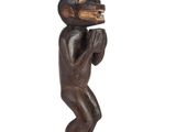 an image of a wooden statue of a man holding a book