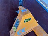 a close up of a yellow crane on the ground