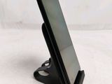 a cell phone that is on a stand on a table