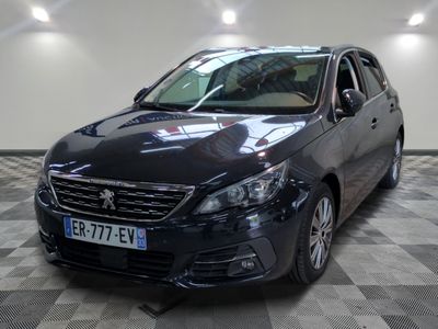 the black car is parked on a checkered floor in the garage