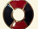 a picture of a red, black, and gold circle brooch