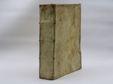 an old book that is sitting on a white surface