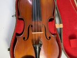 a violin in a red case on a white surface