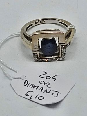 a close up of a ring with a tag on a table