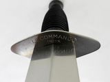 a close up of a knife on a white surface