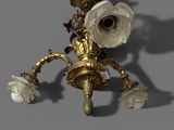 a gold and white flower on a wall sconce