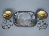 a silver tray with a candle and a candle holder on top of it