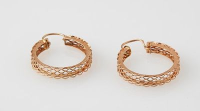 a pair of gold hoop earrings on a white background