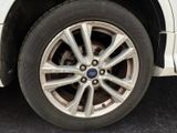 a close up of a tire on a white car