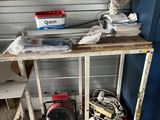 a small table with a fan and other items on it