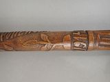 a close up of a wooden stick with carvings on it