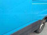 a blue van that is parked on the side of the road