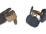 pair of blue and gold cufflinks on a white background
