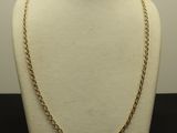 a close up of a mannequin with a chain on it
