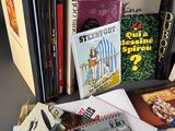 a lot of books on a table with a bunch of them