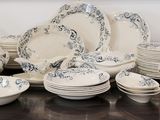 a lot of plates and bowls on the table