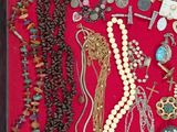 many different types of jewelry displayed in a shadow box