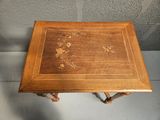 a small wooden table with a floral design on it