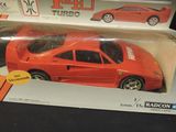 a red toy car in a box on a table