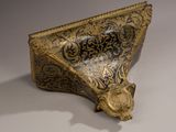 an ornate gold and black box with a lion head on it