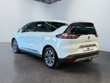 the rear end of a white car in a white room