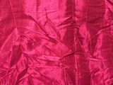 a close up of a pink fabric with a black background
