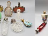 several different types of glass bottles and spoons on a table