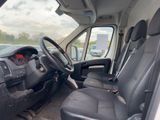 the interior of a white van with black seats and a steering wheel