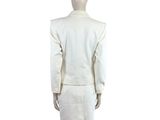 the back view of a mannequin wearing a white suit and skirt