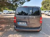 a silver van parked in a parking lot with other cars