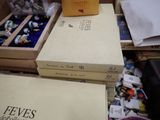 many boxes of books sitting on a table