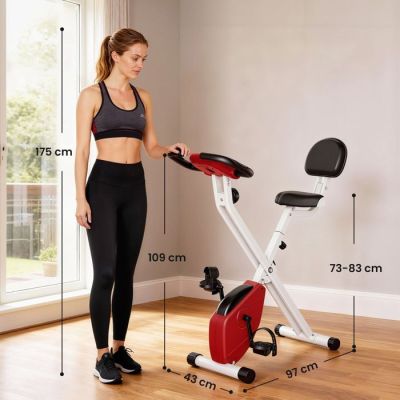 the woman is standing next to an exercise bike in the living room