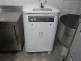 an image of a small kitchen with a washing machine in the corner