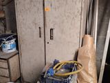 a refrigerator in a room with a lot of stuff on the floor