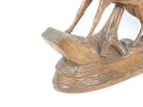 a wooden sculpture of a horse and a bird on a boat