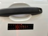 a black handle on the door handle of a white car