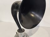 a black and silver horn on a silver stand