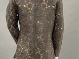 mannequin dressed in black and gold jacket and pants in a museum