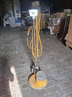 a machine that is sitting on a brick floor