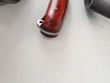 a knife that is laying on a table next to a pair of gloves