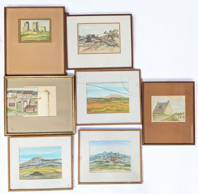 many framed pictures of different landscapes on the wall